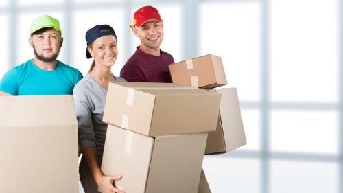 Office furniture and equipment being packed for commercial removals
