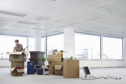 Packed office furniture and labelled boxes ready for relocation